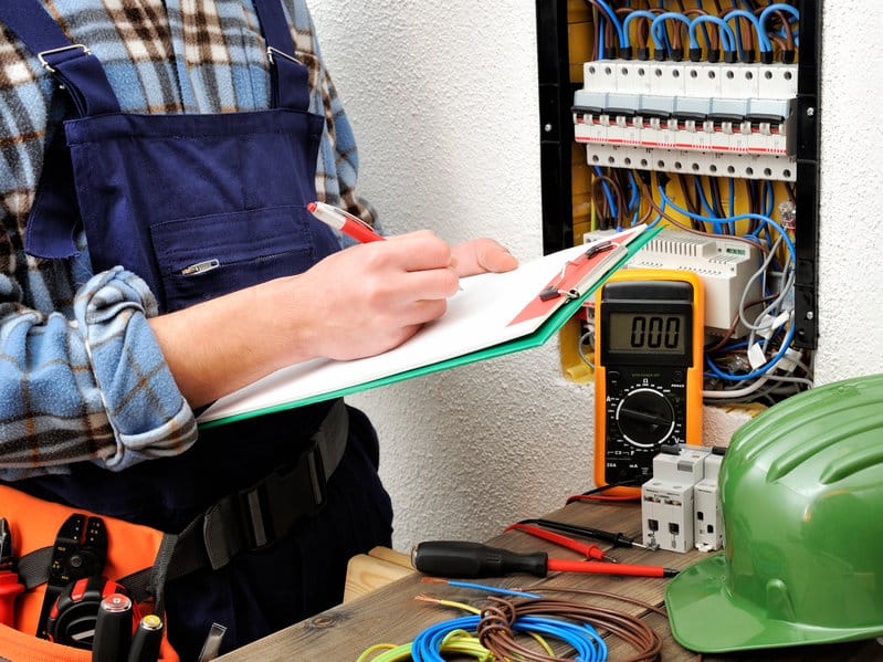 young electrician technician at work on a electrical panel